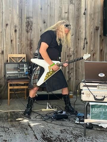 Larry playing the quitar on stage.